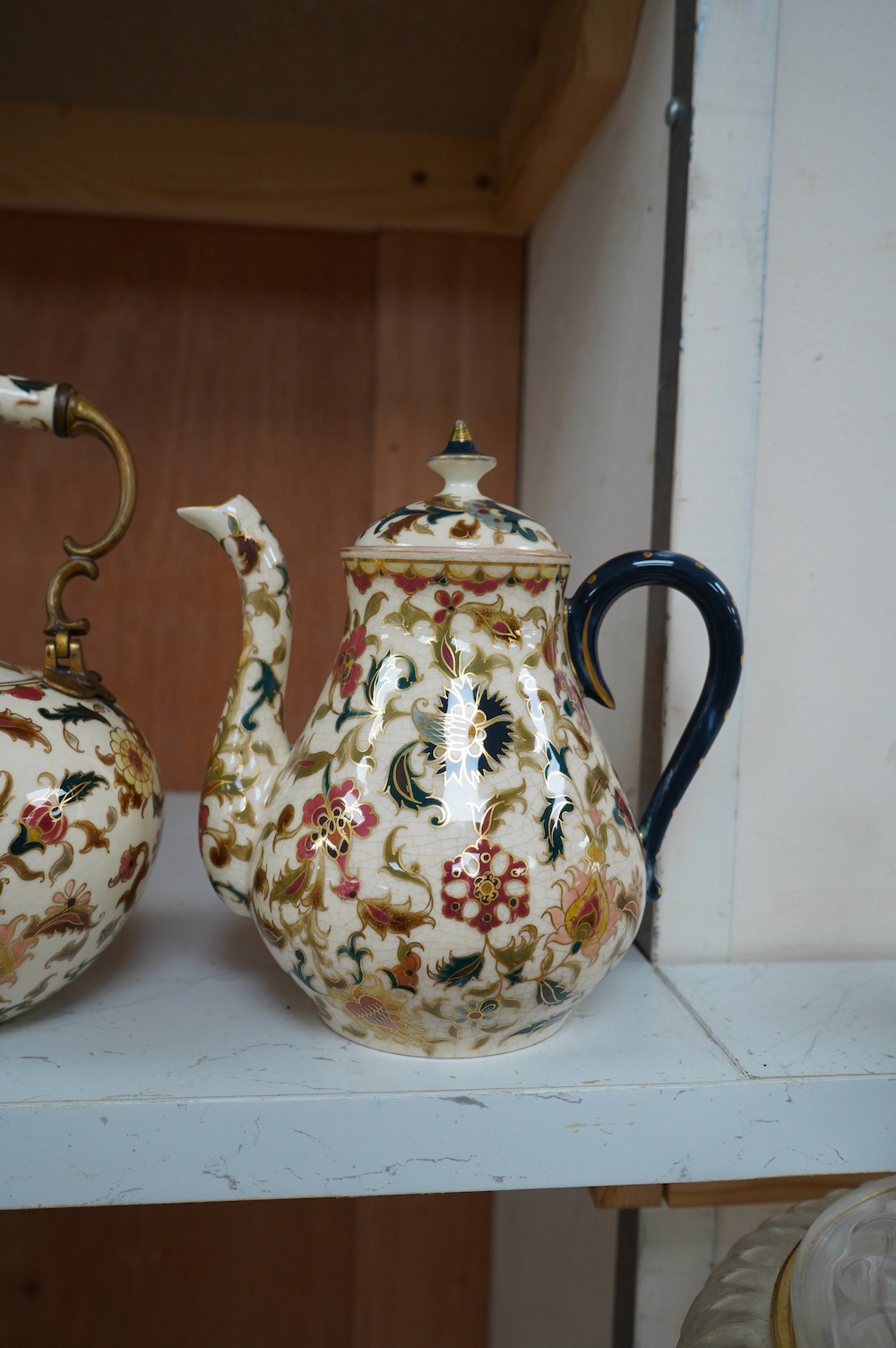 A matched Hungarian Zsolnay floral three piece tea set, largest 17cm high. Condition - fair, crazing throughout